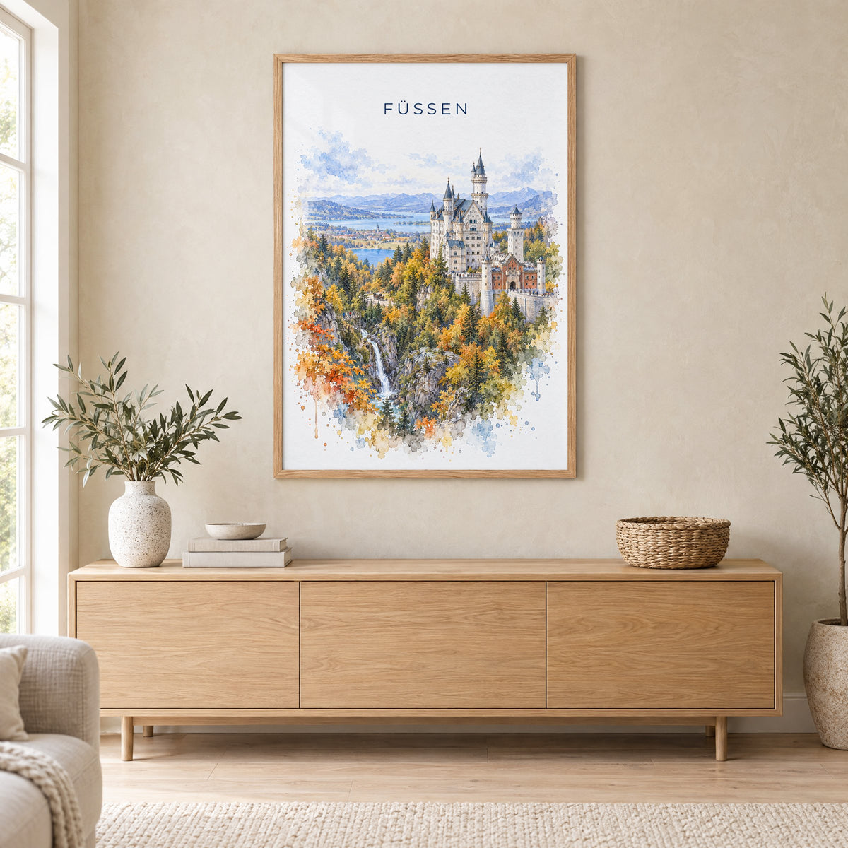 Füssen watercolor print in an oak frame above a light wood sideboard in a Scandinavian living room