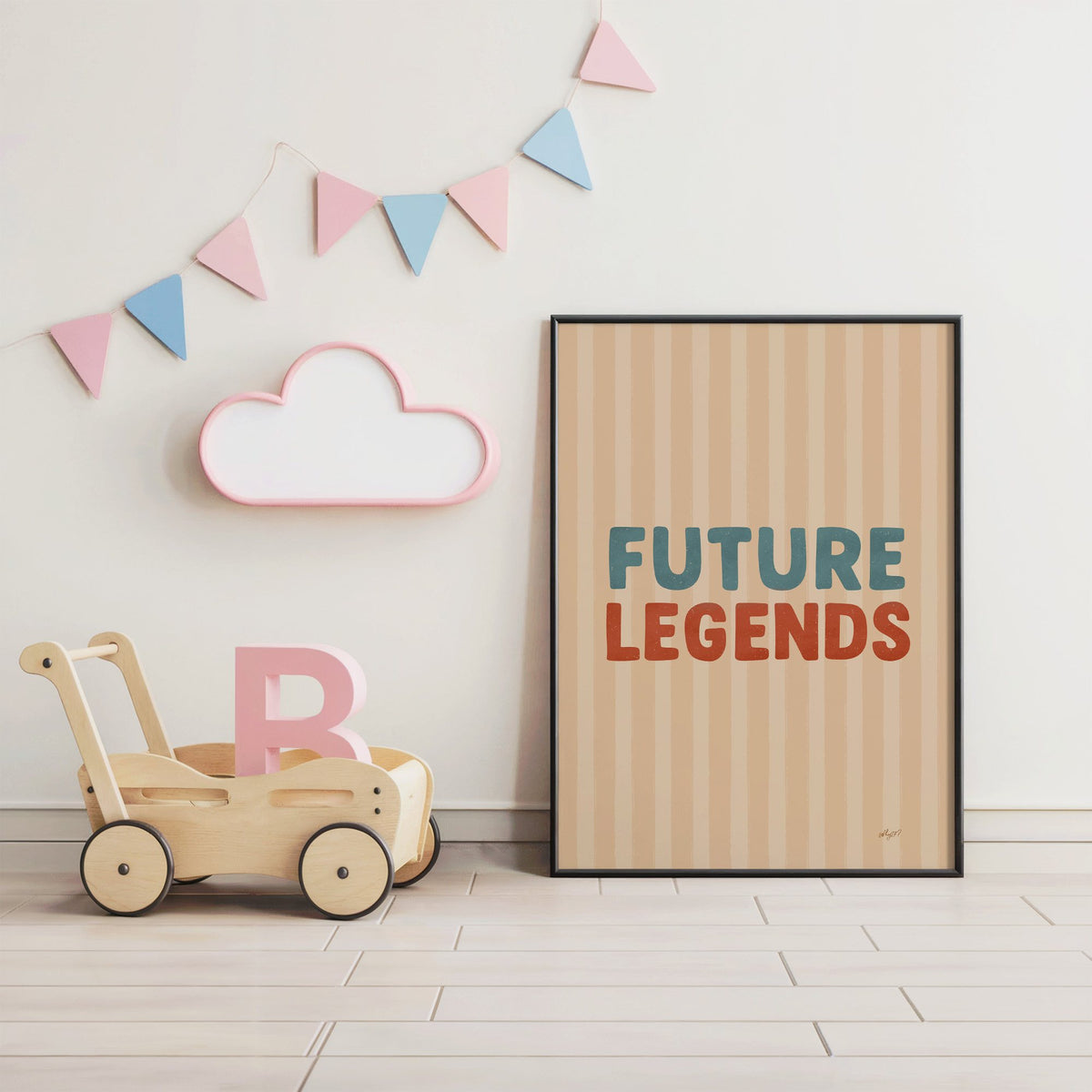 Future legends retro lettering nursery print in a black frame under pastel bunting by a wooden baby walker