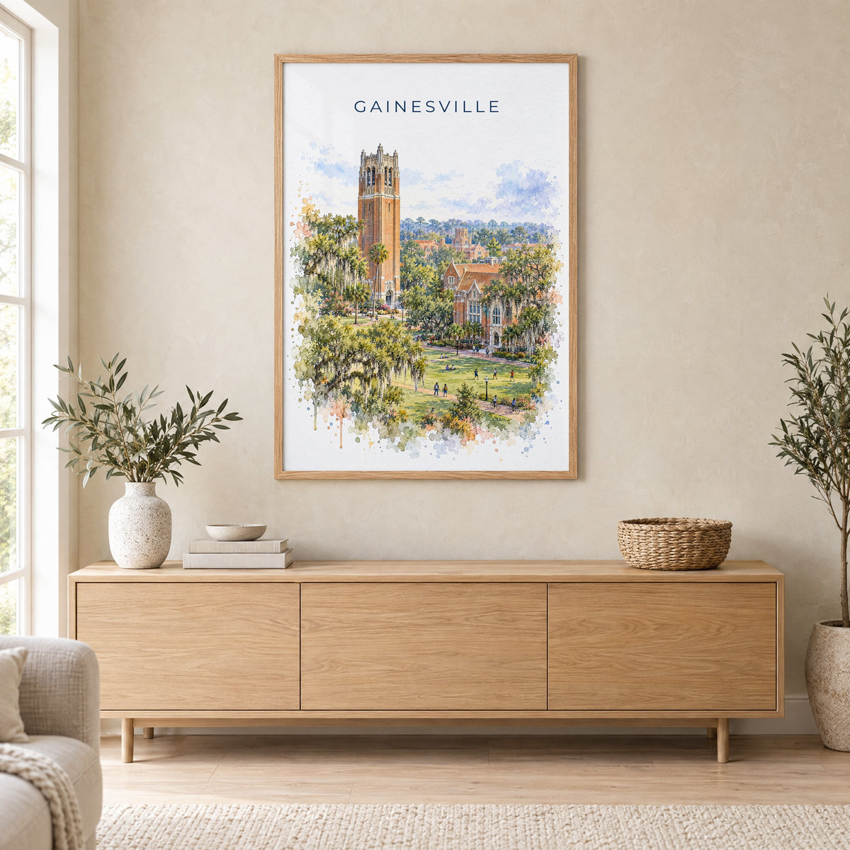 Gainesville, Florida watercolor print in an oak frame above a light wood sideboard in a Scandinavian living room