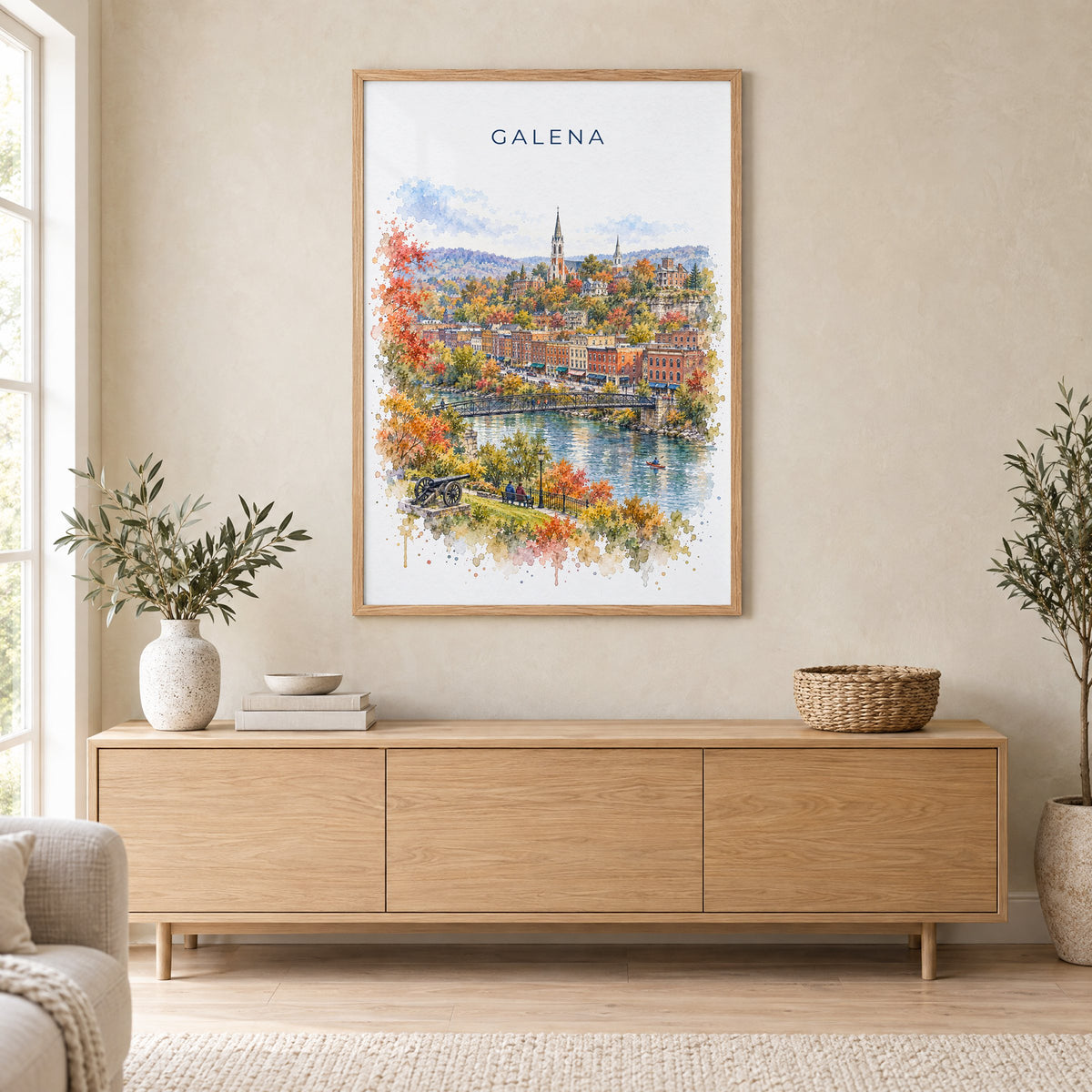 Galena, Illinois watercolor print in an oak frame above a light wood sideboard in a Scandinavian living room