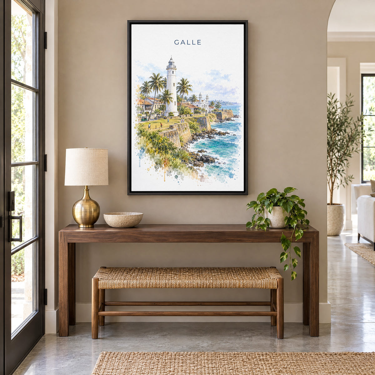 Galle, Sri Lanka watercolor print as a black floater canvas above a walnut console and woven bench in an entryway