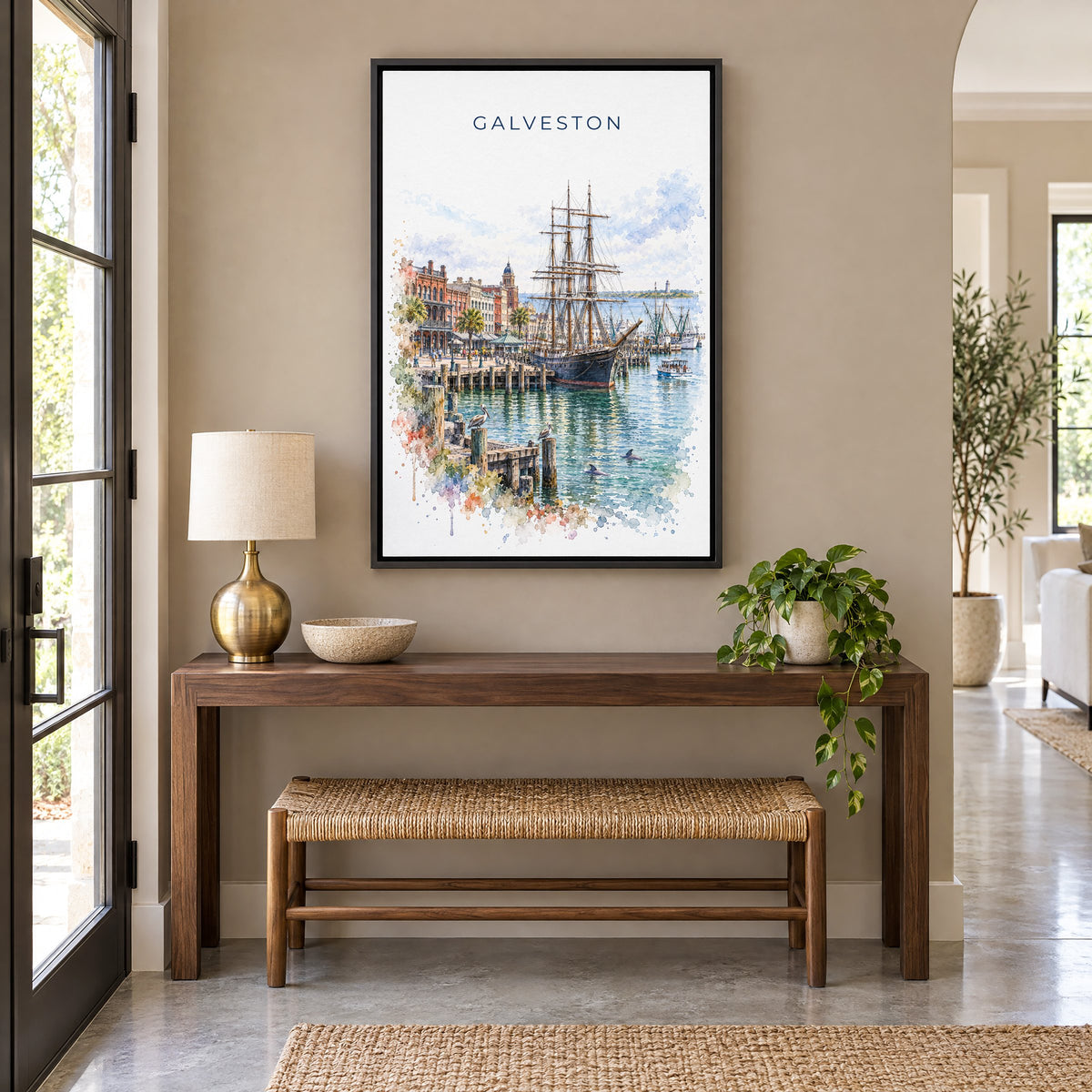 Galveston watercolor print as a black floater canvas above a walnut console and woven bench in an entryway