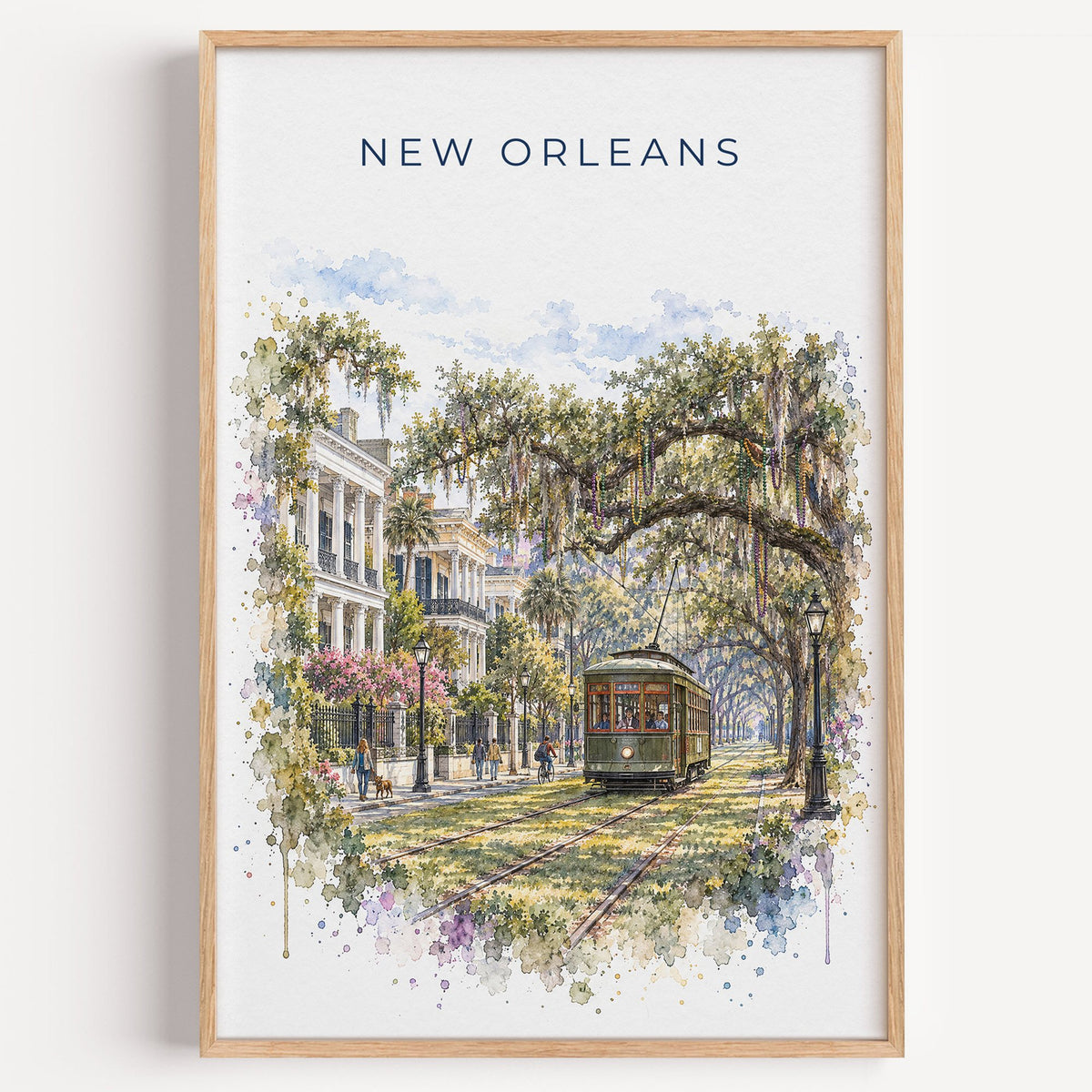 Garden District New Orleans watercolor print in a light oak frame on a plain white wall