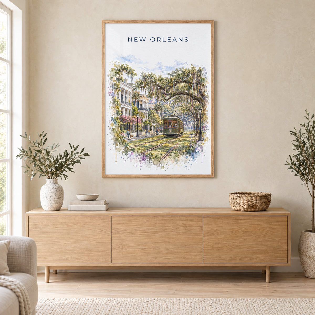 Garden District New Orleans watercolor print in an oak frame above a light wood sideboard in a Scandinavian living room