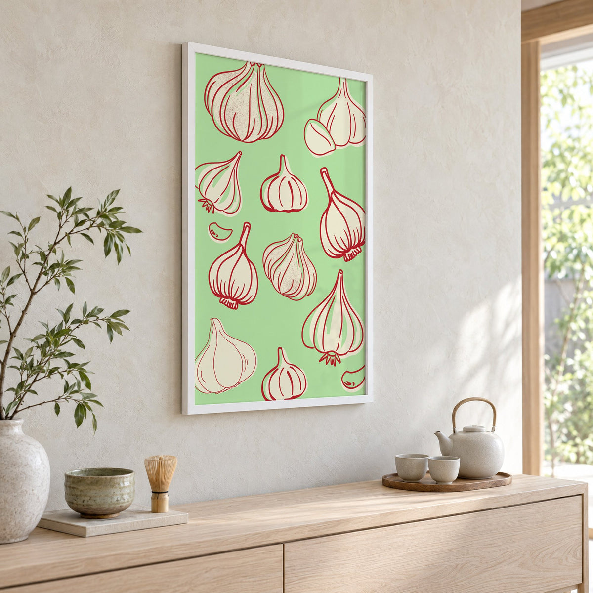 Garlic bulbs red line mint pattern in a white frame above a pale wood console with a matcha tea set