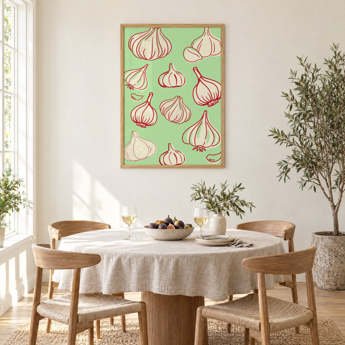 Garlic bulbs red line mint pattern in an oak frame above a round linen-covered dining table with figs and wine
