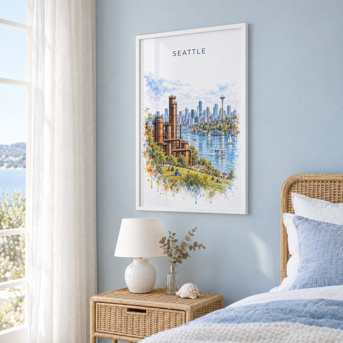 Gas Works Park Seattle watercolor print in a white frame on a pale blue wall beside a rattan bed in a coastal bedroom