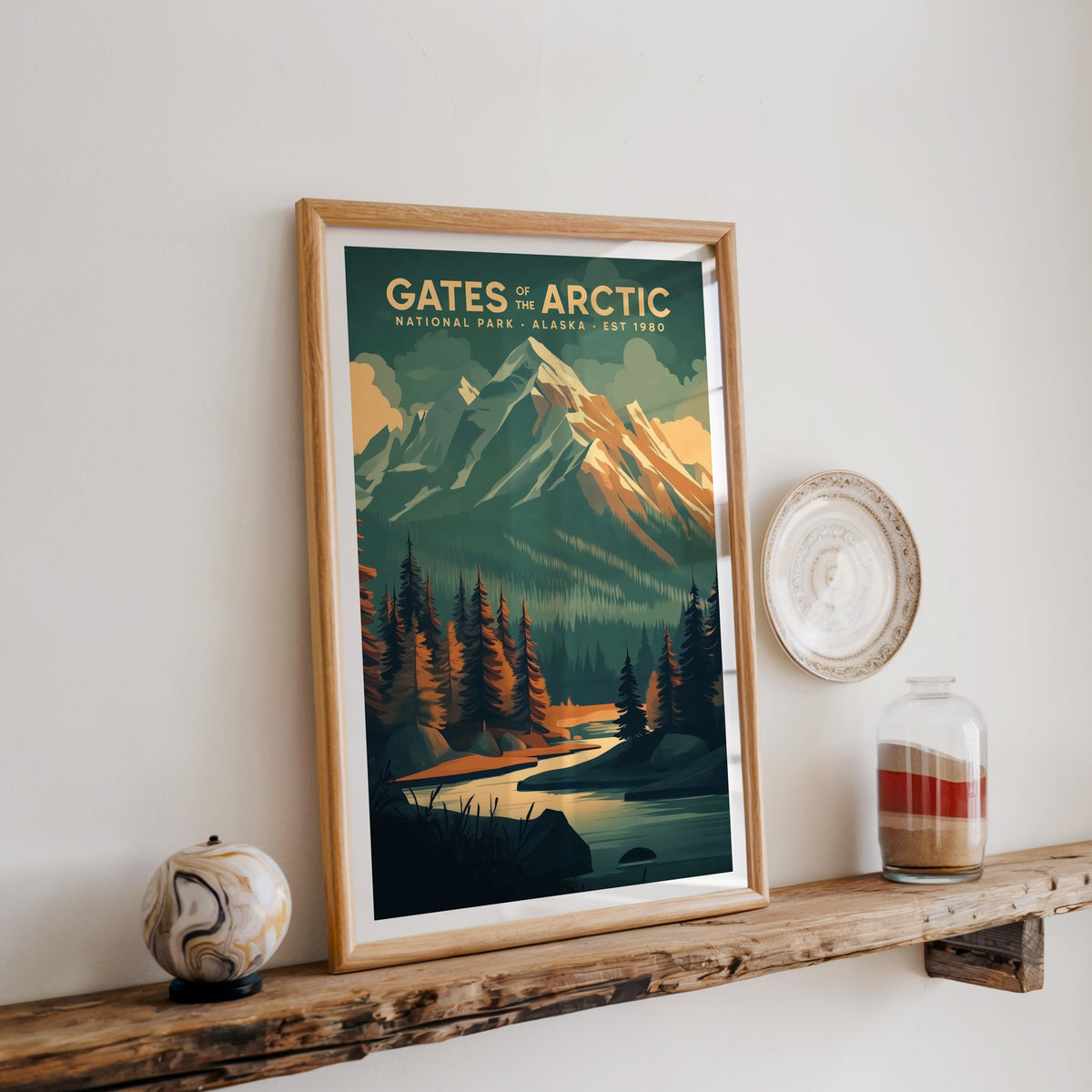 Gates of the Arctic print in an oak frame on a rustic wood shelf with ceramics and a jar