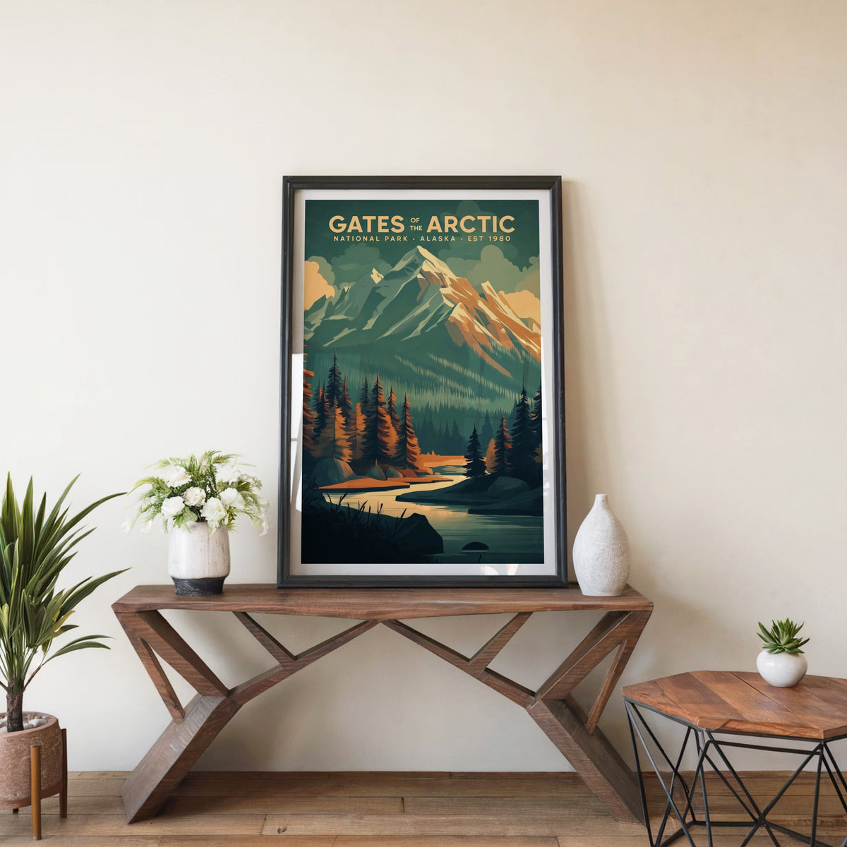 Gates of the Arctic poster in a black frame on an entryway console table with white flowers