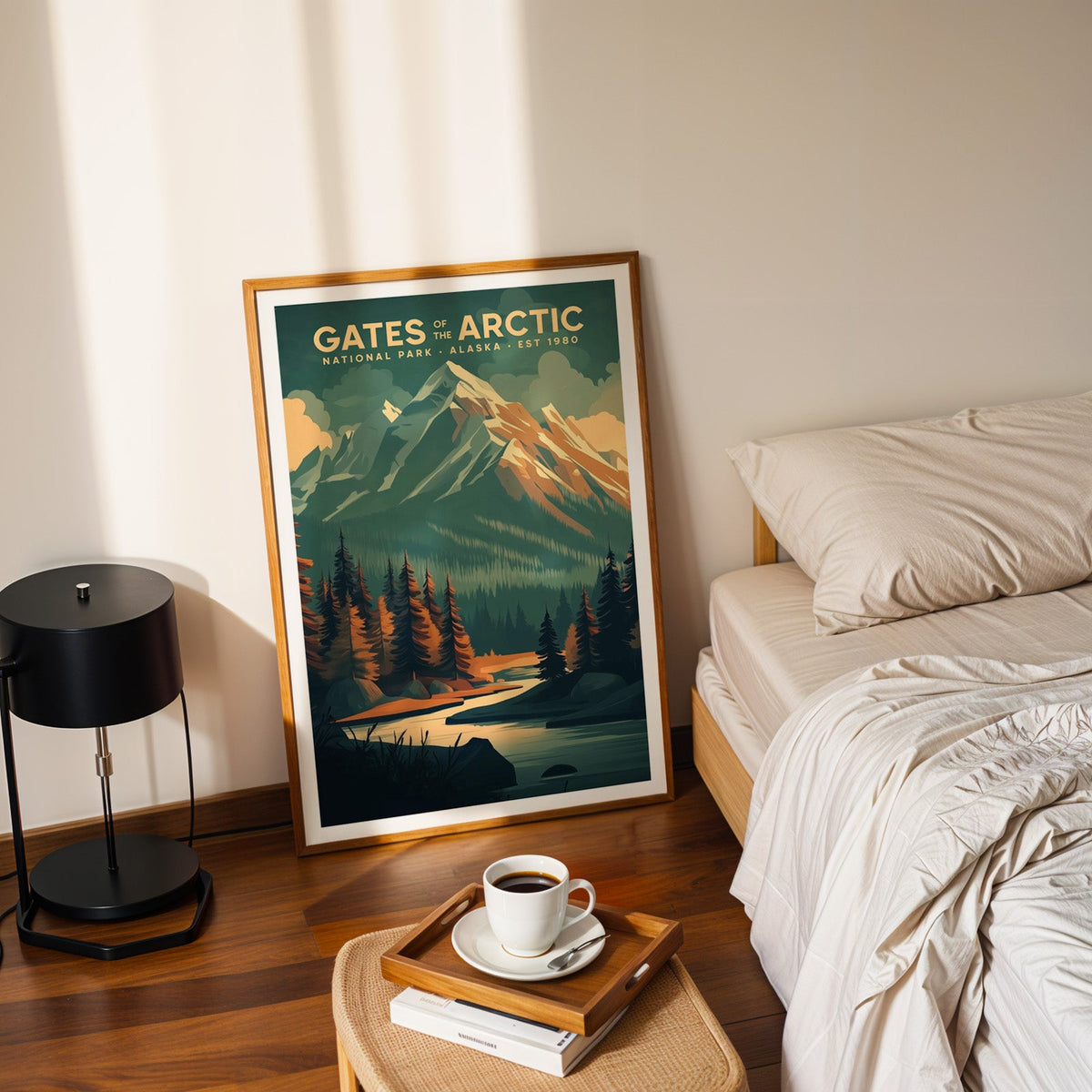 Gates of the Arctic print in an oak frame leaning on a bedroom floor beside the bed and a tray