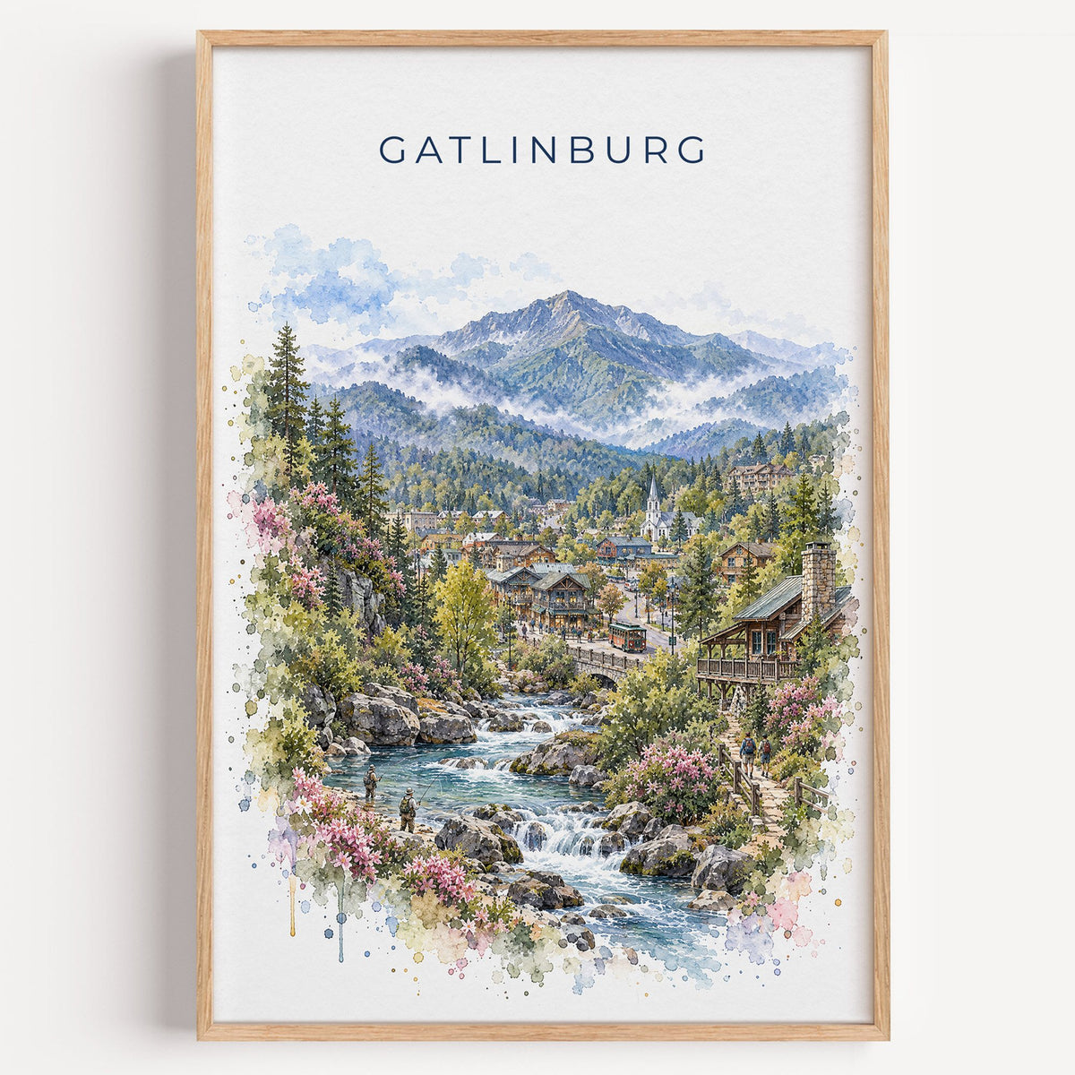 Gatlinburg watercolor print in a light oak frame on a plain white wall