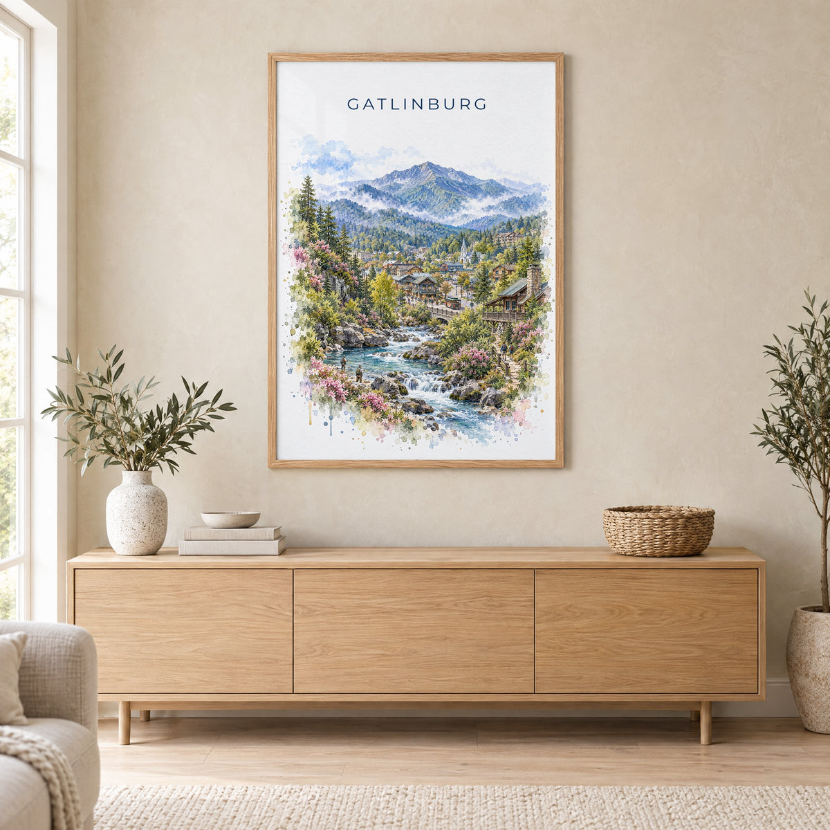 Gatlinburg watercolor print in an oak frame above a light wood sideboard in a Scandinavian living room