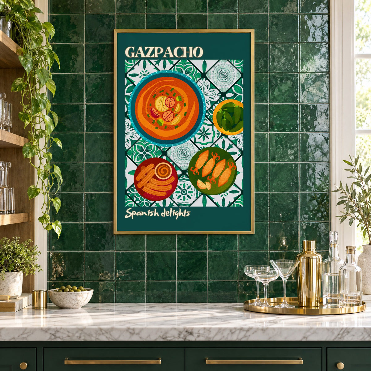 Gazpacho tapas print with teal border in a brass frame on emerald green tiles above a home bar with coupe glasses
