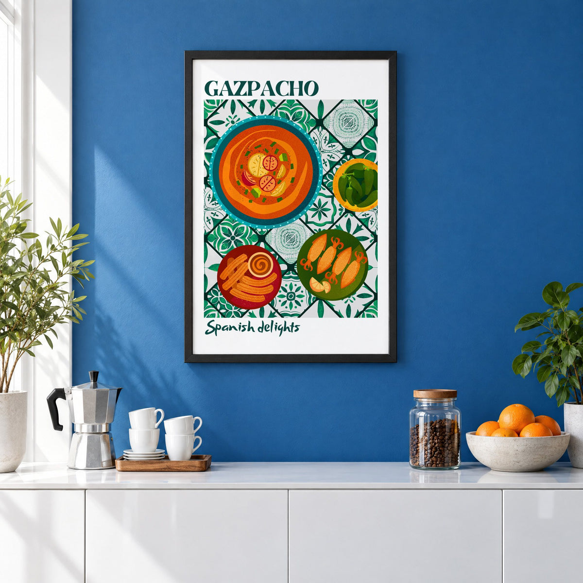 Gazpacho tapas print with white border in a black frame on a cobalt blue wall above a coffee station