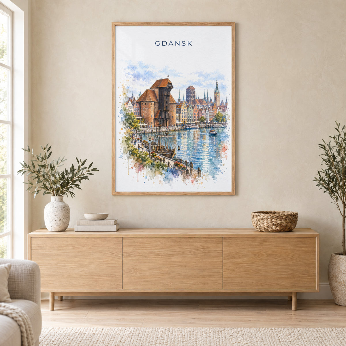 Gdansk watercolor print in an oak frame above a light wood sideboard in a Scandinavian living room