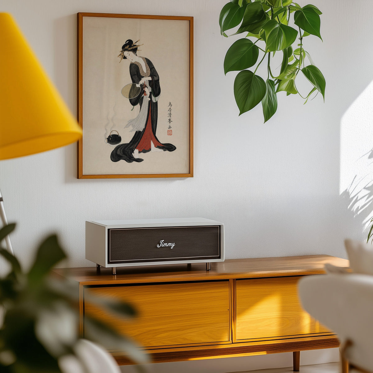 woman in black kimono with fan print in an oak frame above a teak mid-century sideboard with trailing pothos