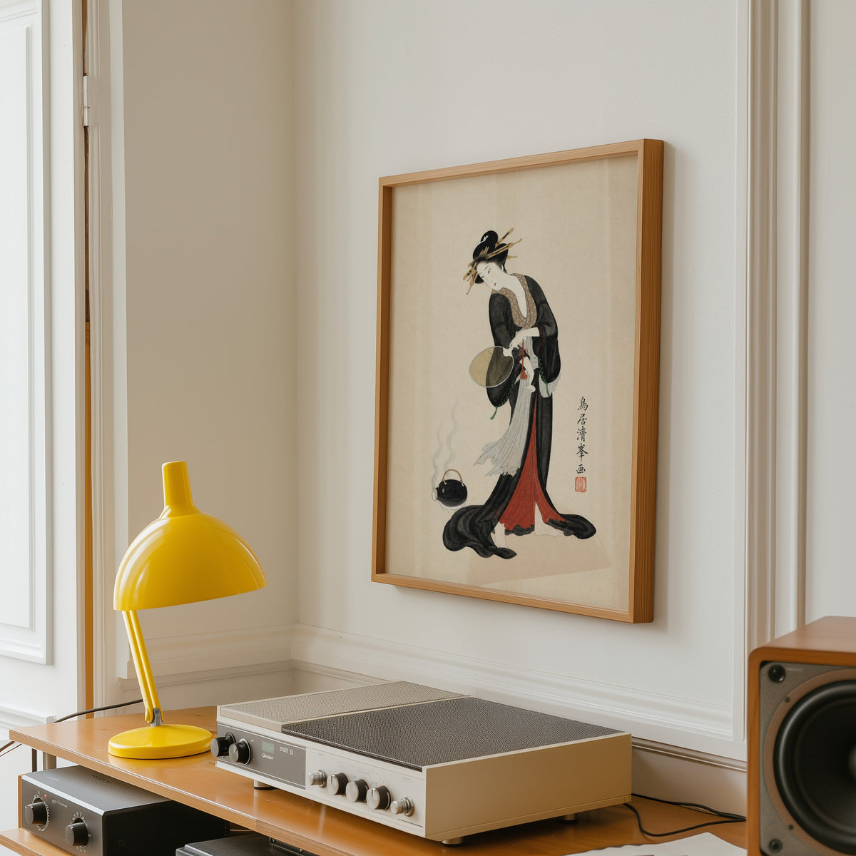 woman in black kimono with fan print in an oak frame above a vintage hi-fi shelf with a yellow desk lamp