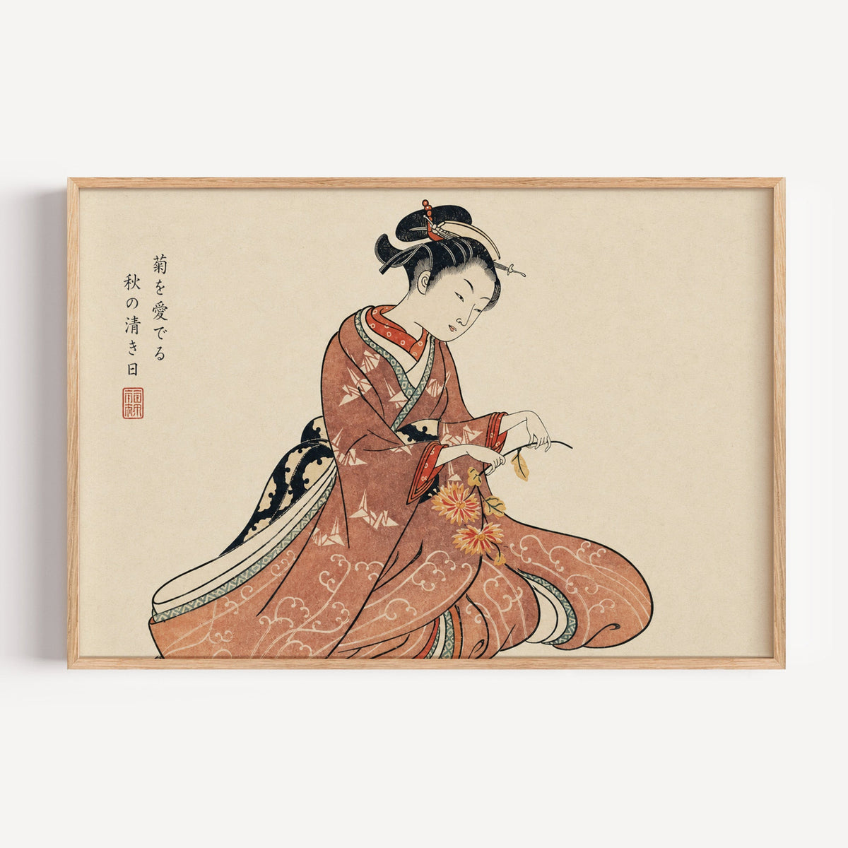 Kimono woman holding chrysanthemums print in a light oak frame on a plain white wall