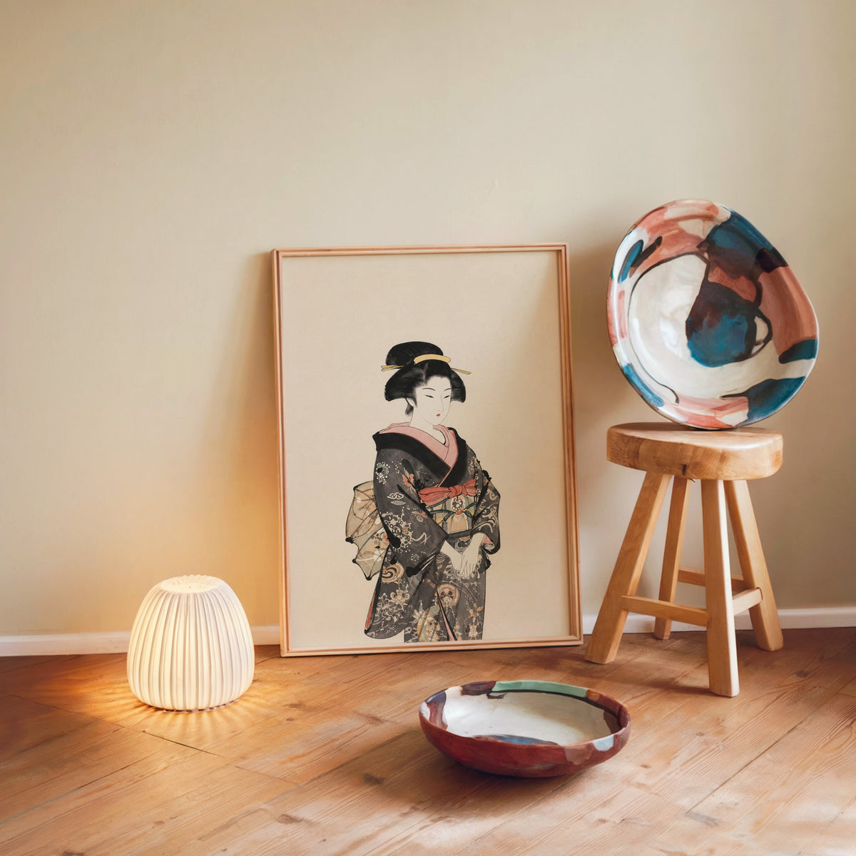 woman in dark floral kimono print in a light wood frame leaning on a wooden floor by a glowing lamp and stool