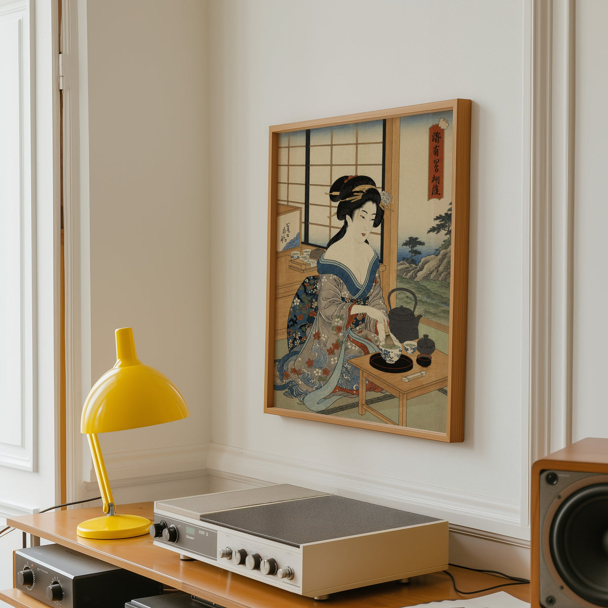 woman whisking matcha tea print in an oak frame above a vintage hi-fi shelf with a yellow desk lamp