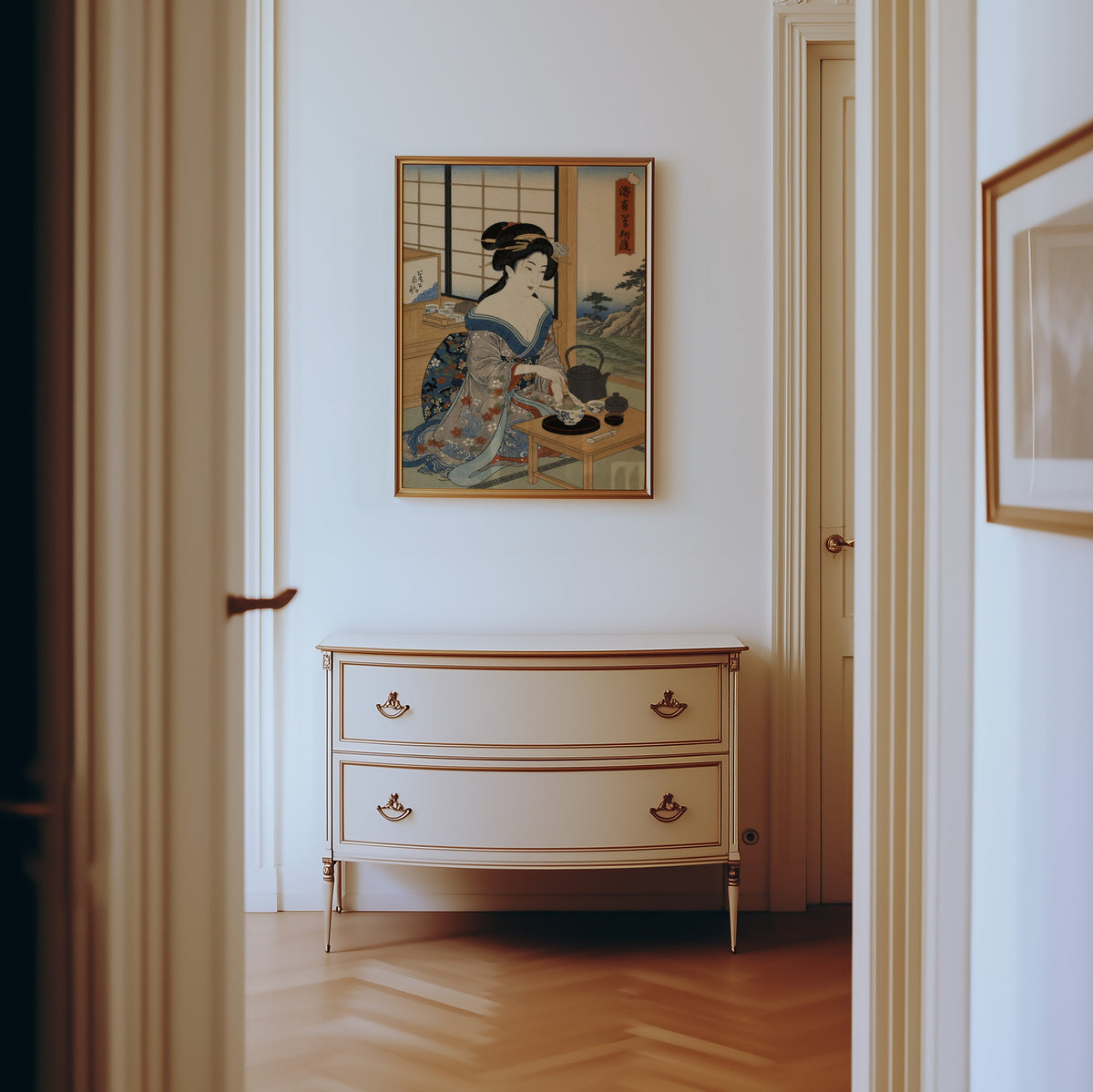 woman whisking matcha tea print shown in a gold frame in a hallway above a cream dresser