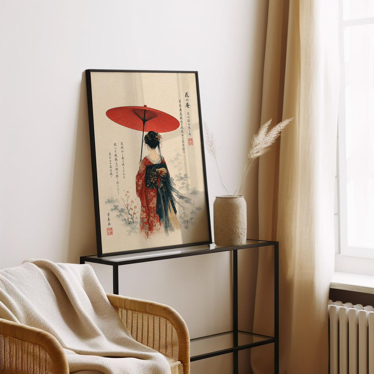 woman with red paper parasol print in a black frame leaning on a glass console beside pampas grass