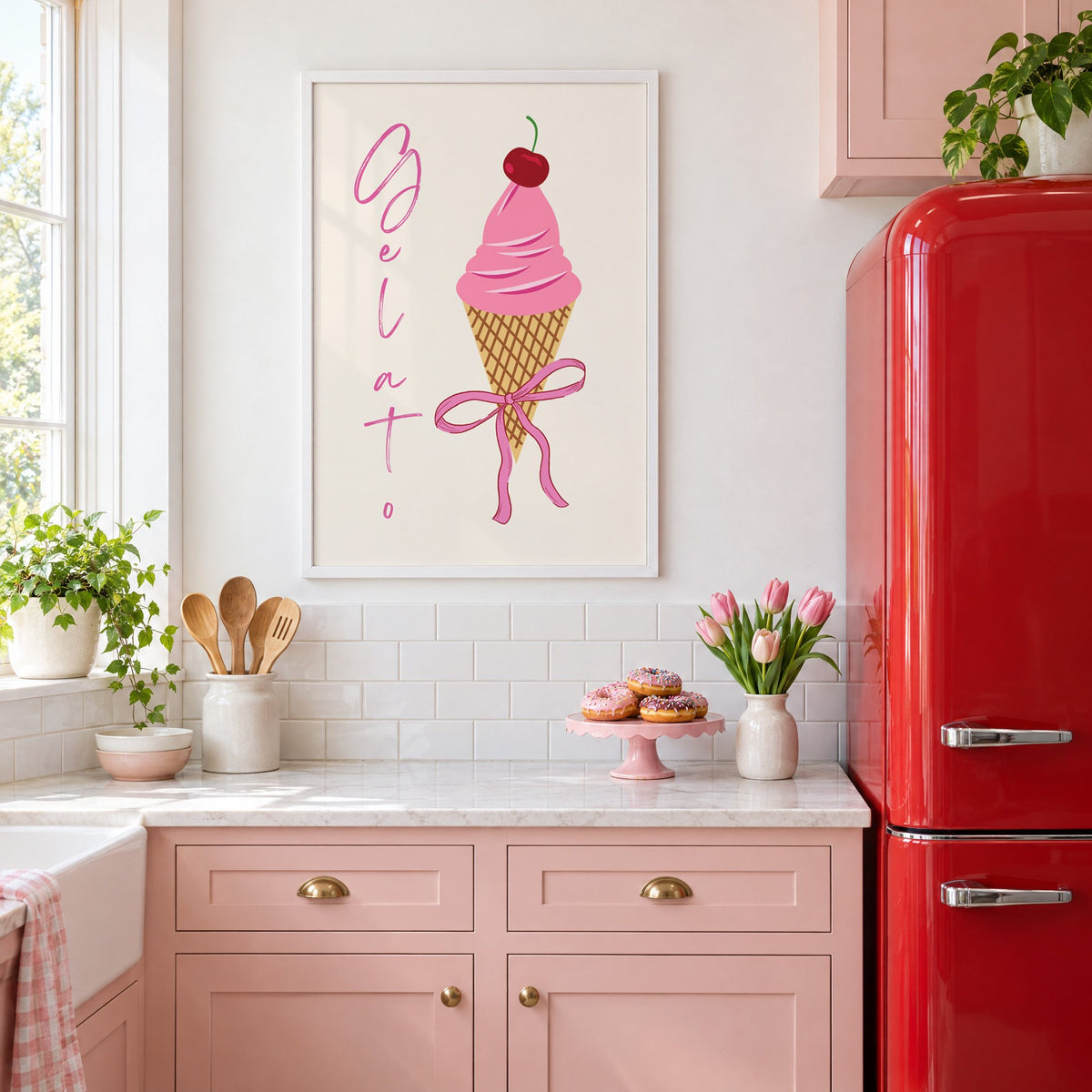 Gelato pink cone with bow print in a white frame in a pink kitchen beside a red retro fridge