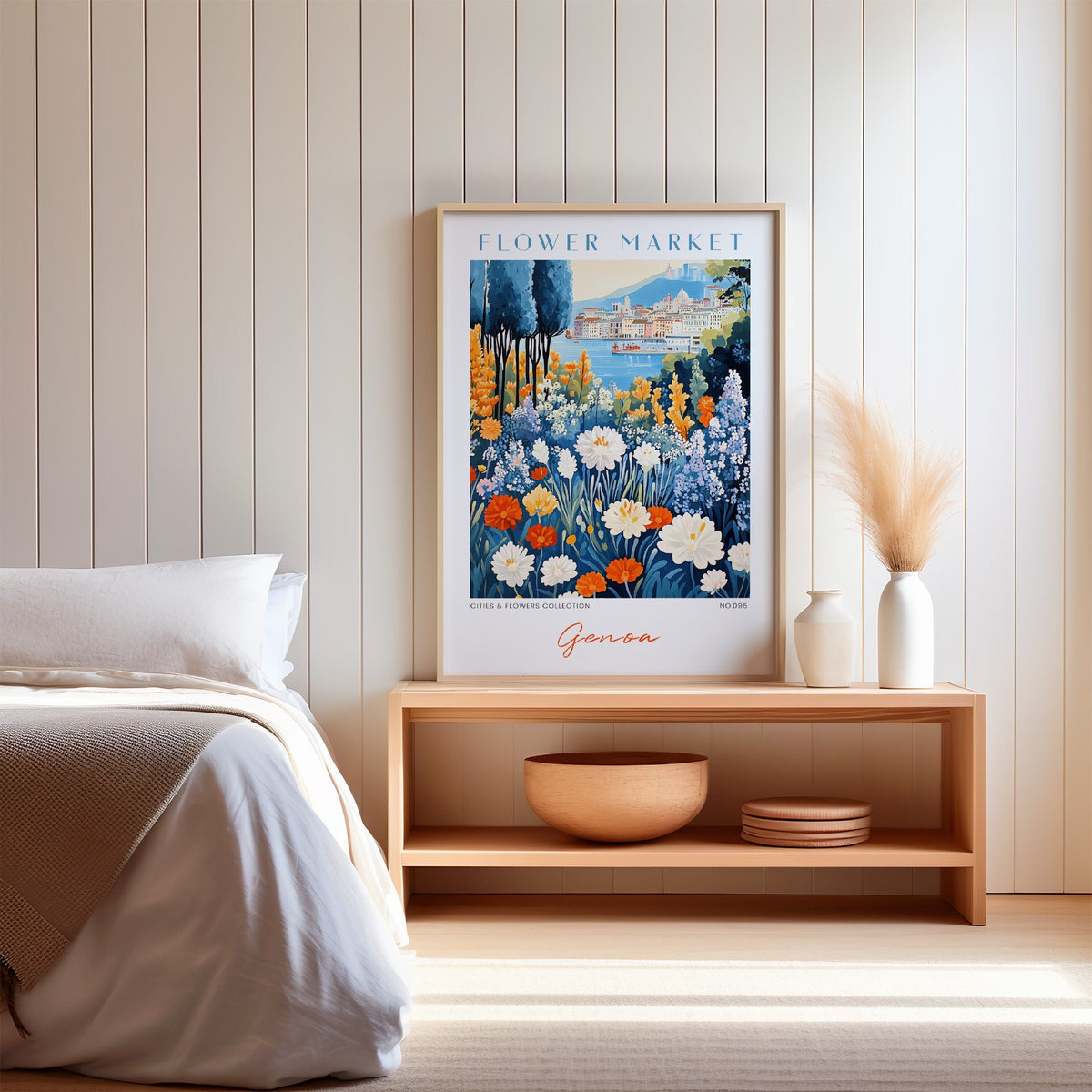 Genoa flower market print in an oak frame on a wood bench against a white shiplap bedroom wall with pampas grass