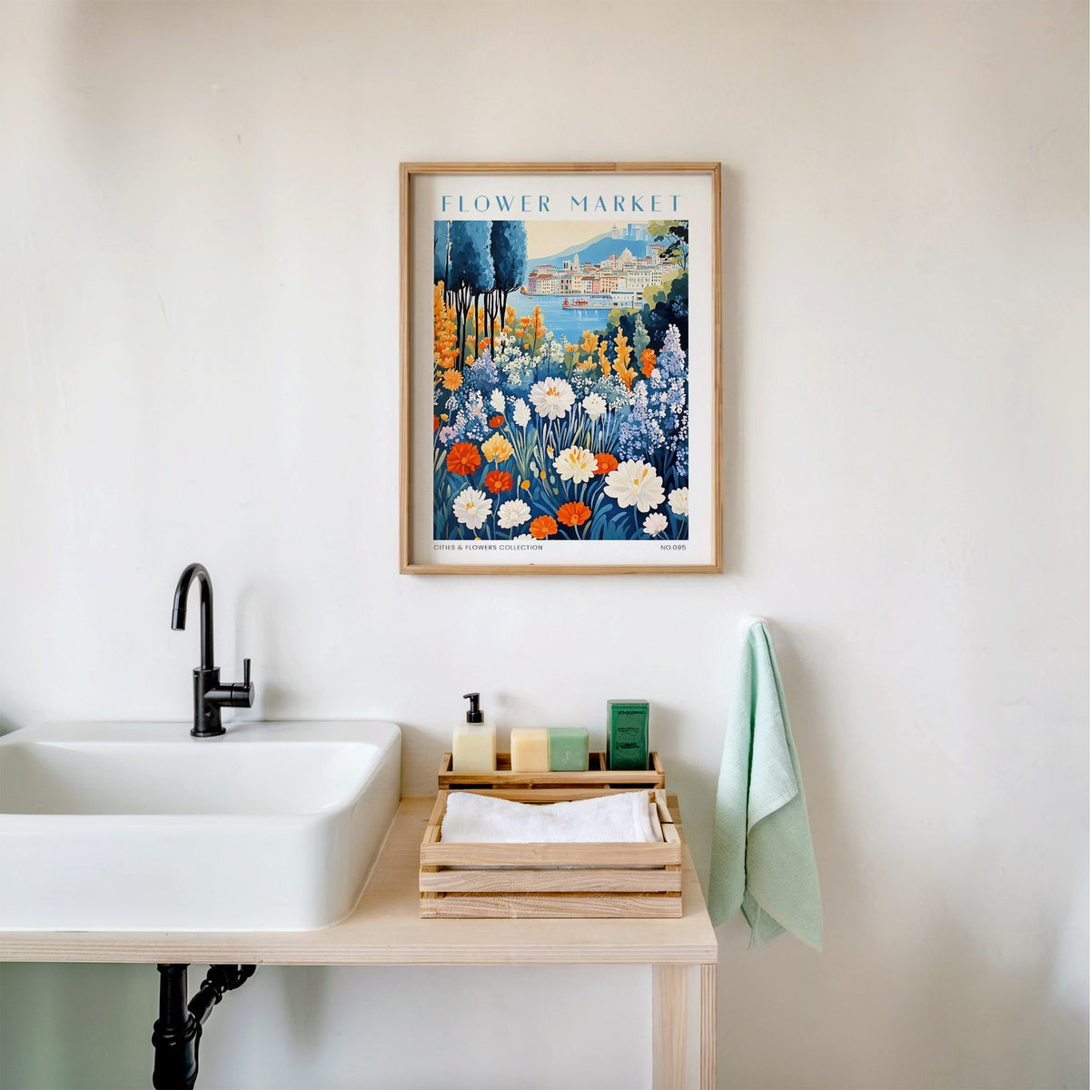Genoa flower market print in an oak frame above a white bathroom sink with folded towels