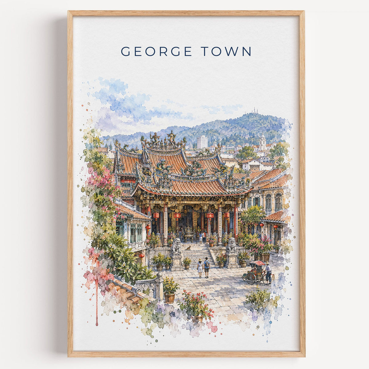 George Town, Malaysia watercolor print in a light oak frame on a plain white wall