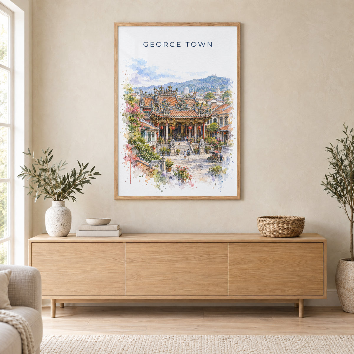 George Town, Malaysia watercolor print in an oak frame above a light wood sideboard in a Scandinavian living room