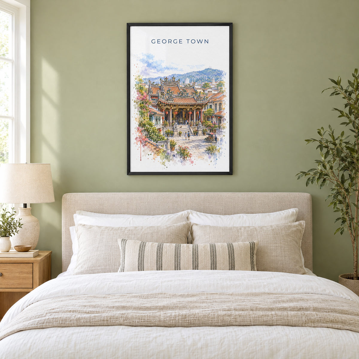 George Town, Malaysia watercolor print in a black frame above an upholstered headboard in a sage green bedroom