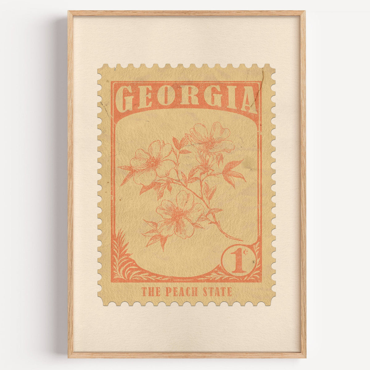 Georgia state flower stamp print in soft orange on wheat, light oak frame on a plain white wall