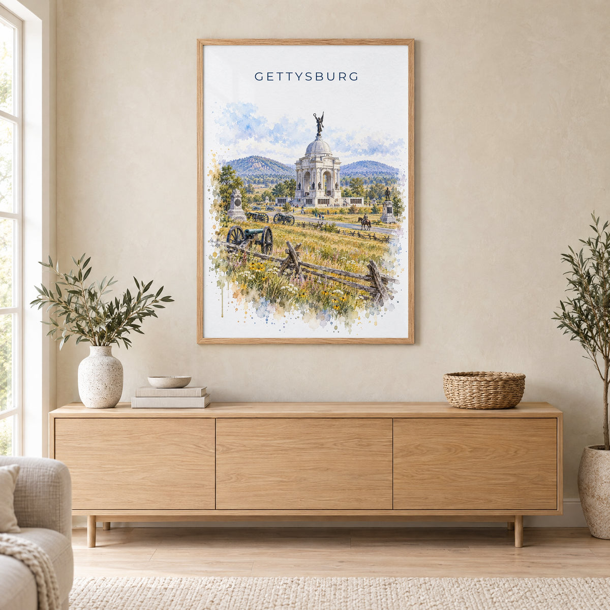 Gettysburg watercolor print in an oak frame above a light wood sideboard in a Scandinavian living room