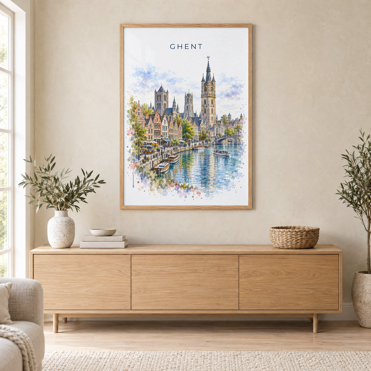 Ghent watercolor print in an oak frame above a light wood sideboard in a Scandinavian living room