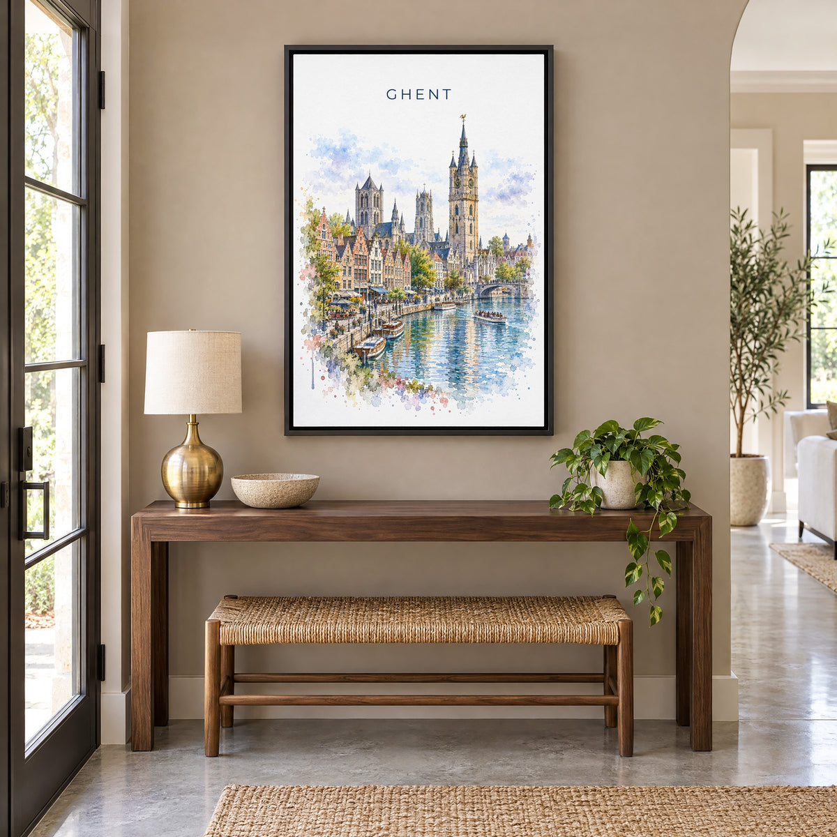 Ghent watercolor print as a black floater canvas above a walnut console and woven bench in an entryway