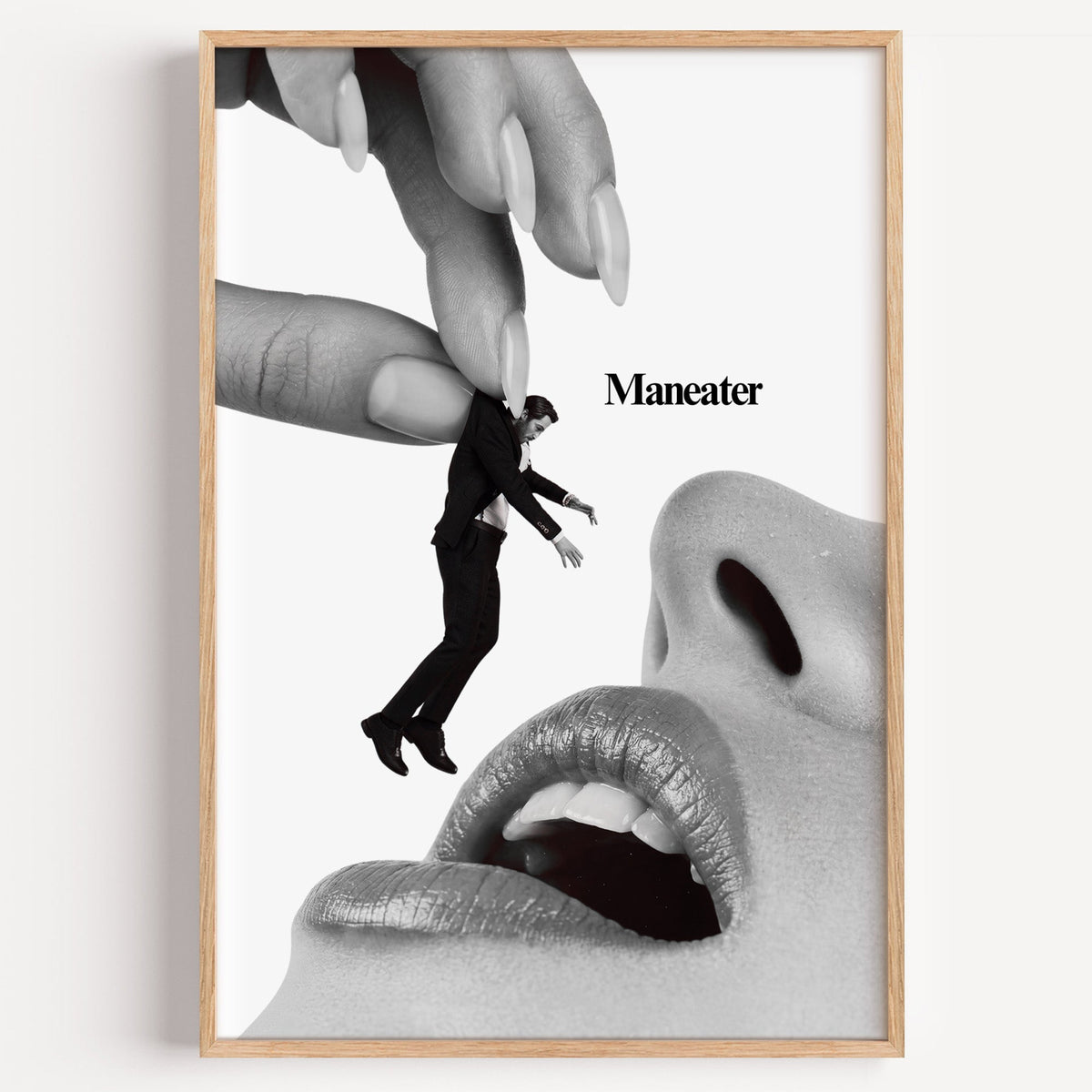 Giant hand lifting tiny suited man collage print in a light oak frame on a plain white wall