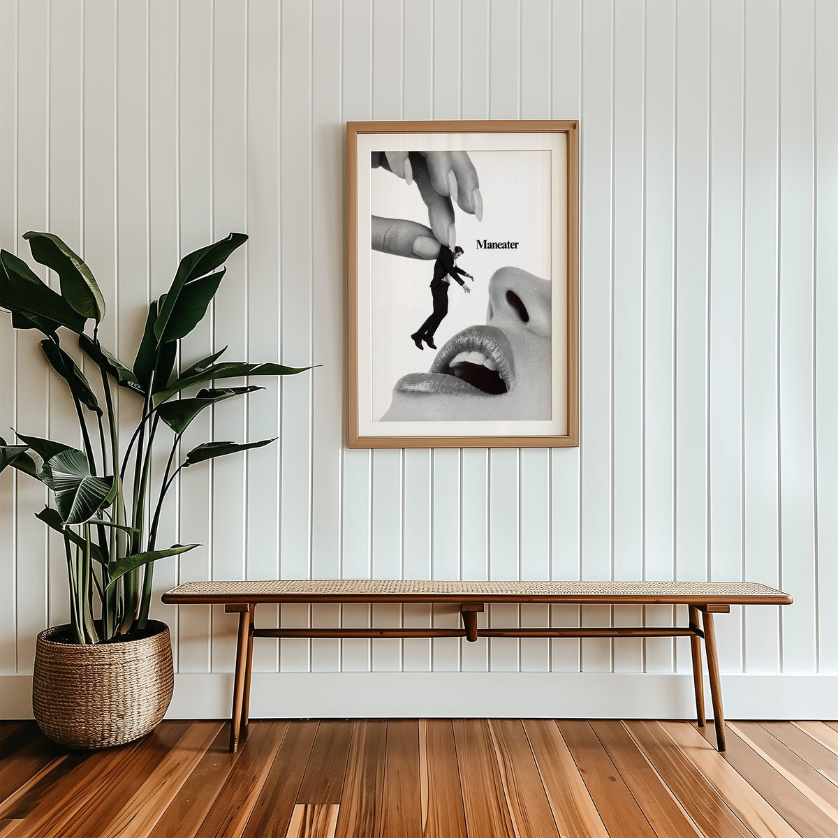 Giant hand lifting tiny suited man collage print in a wood frame with a white mat above a cane bench