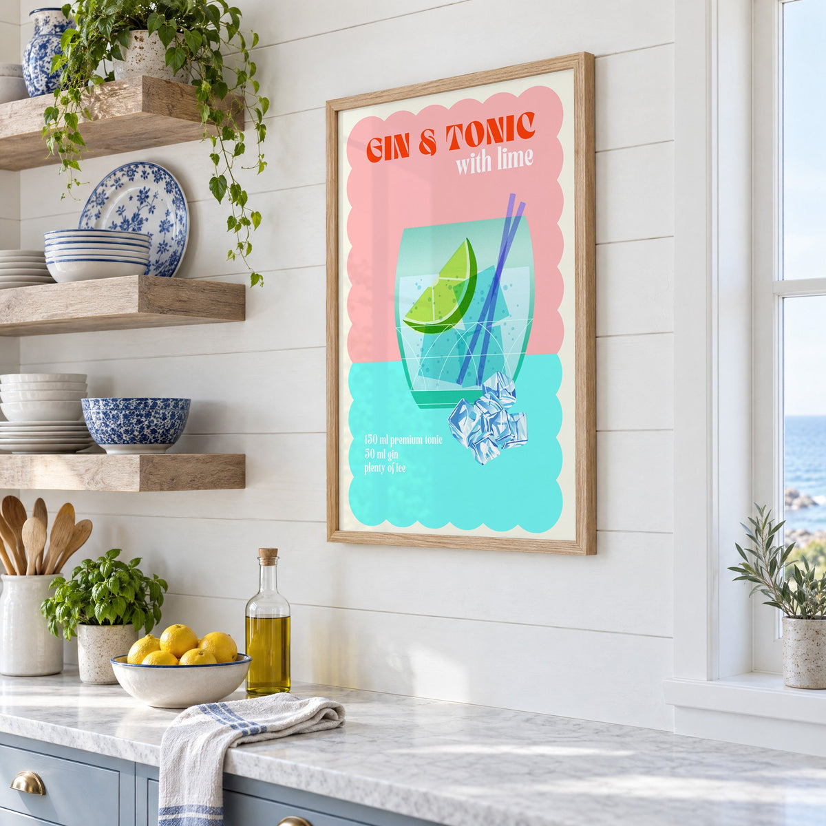 Gin & Tonic with lime aqua print in an oak frame in a white coastal kitchen beside blue and white plates