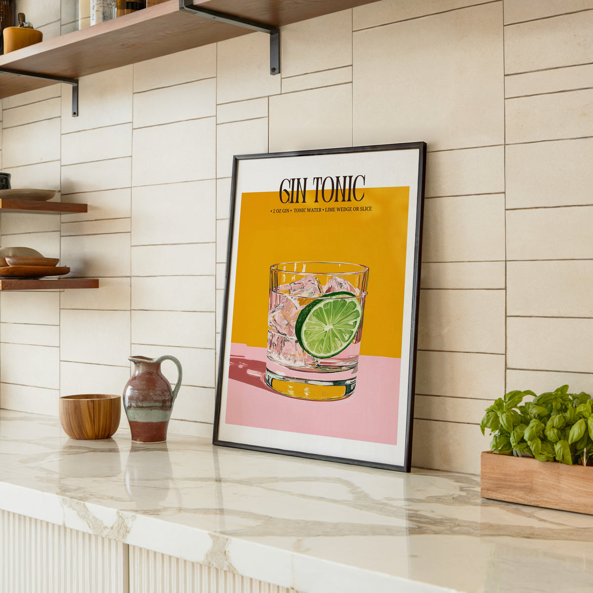 Gin and tonic recipe print in a black frame leaning on a marble counter in a tiled kitchen
