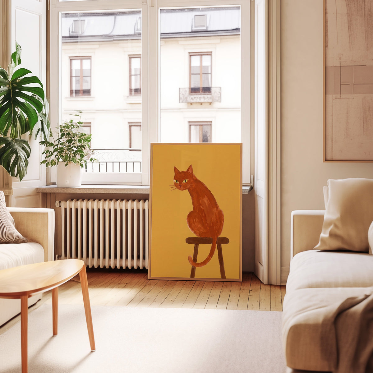 Cat looking back print in an oak frame leaning below tall French windows