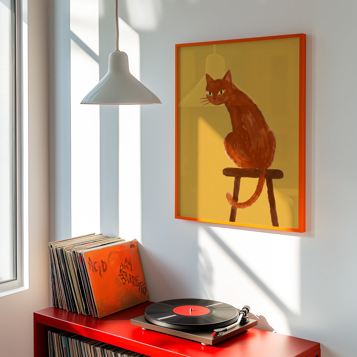 Cat looking back print shown in an orange frame above a red record cabinet and turntable