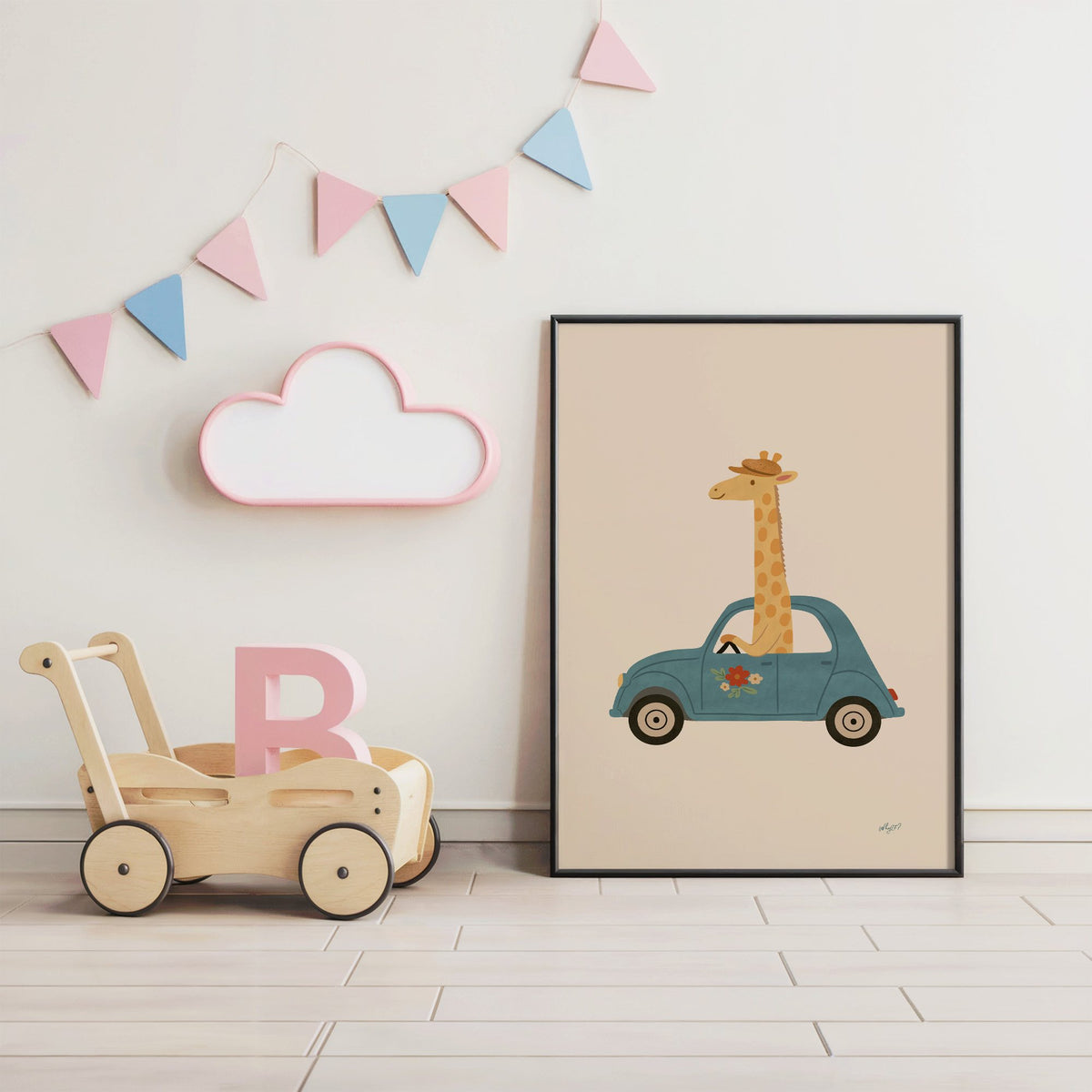 Giraffe driving a teal car nursery print in a black frame under pastel bunting by a wooden baby walker