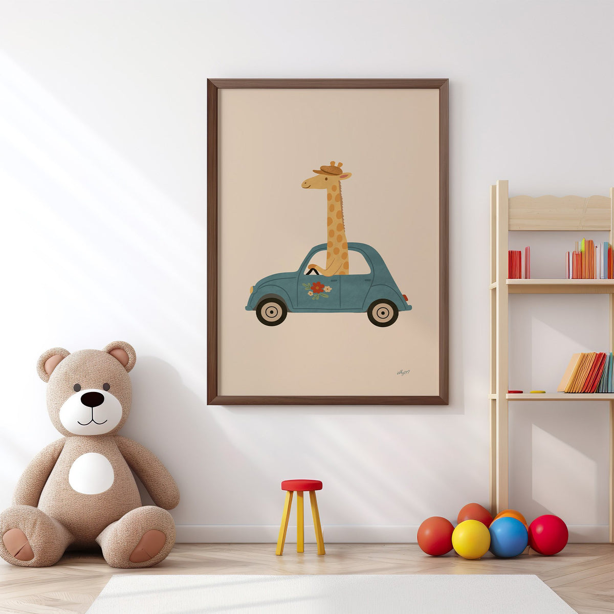 Giraffe driving a teal car nursery print in a walnut frame above a big teddy bear by a bookshelf