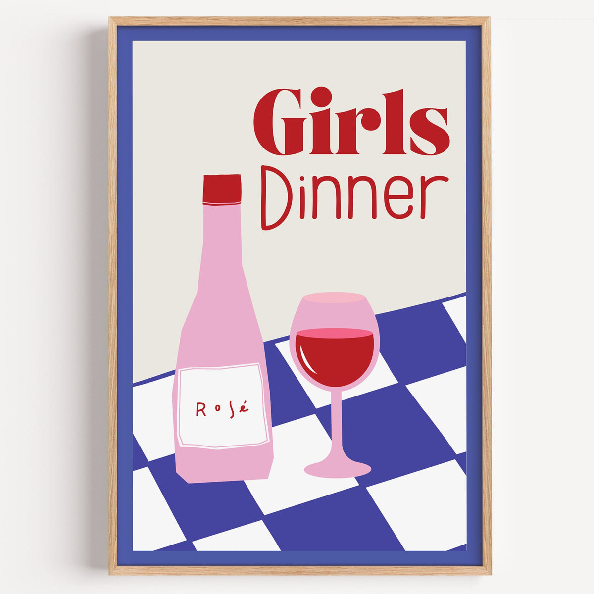 Girls Dinner rosé bottle on checkered table print in a light oak frame on a plain white wall