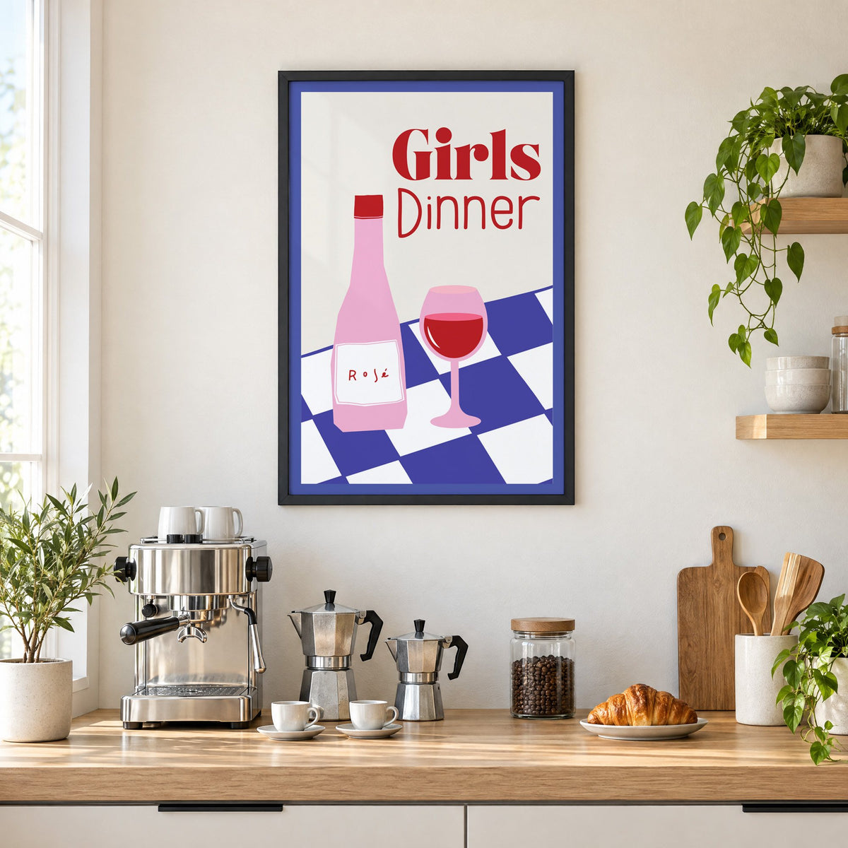 Girls Dinner rosé bottle on checkered table print in a black frame above a home espresso bar with moka pots and espresso cups