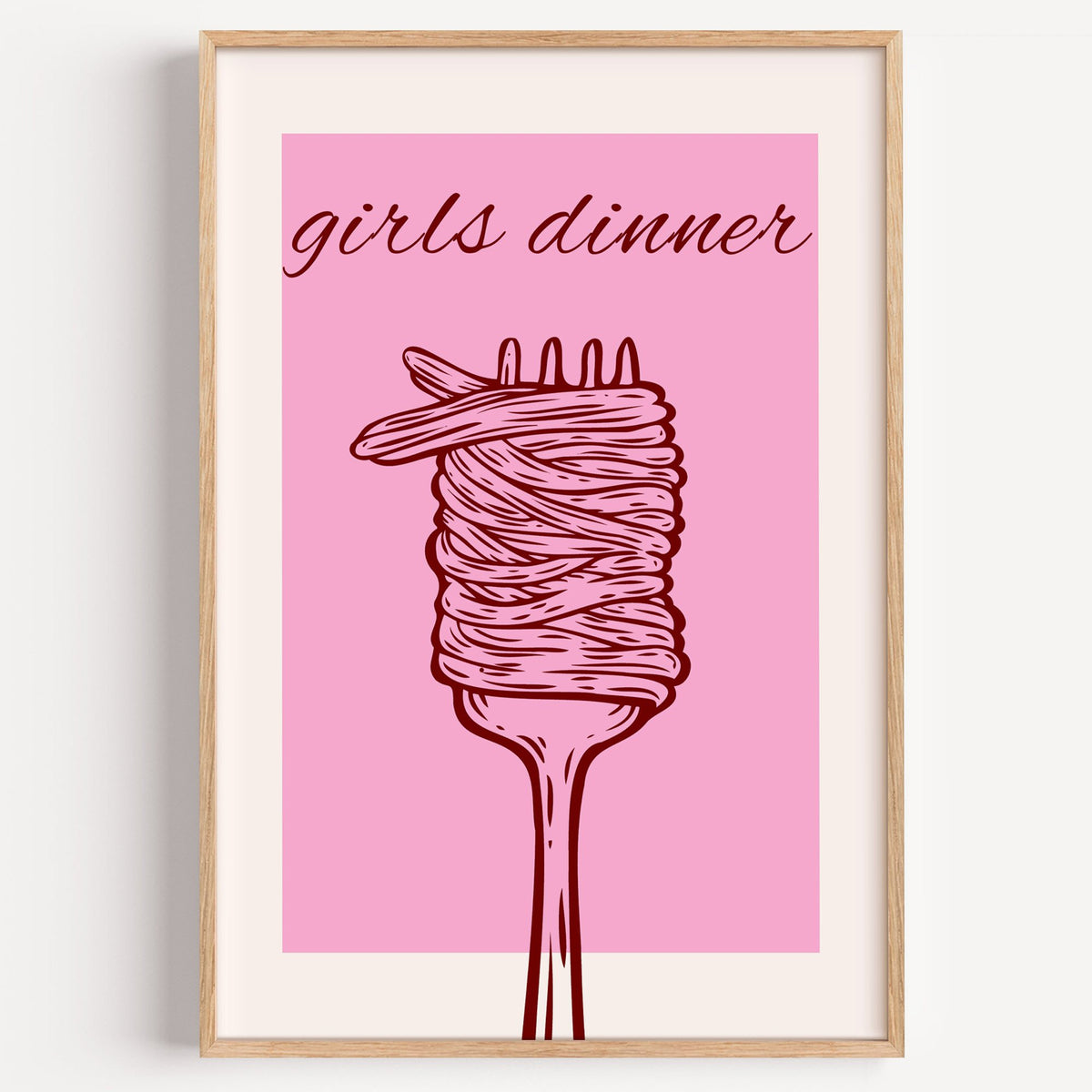 Girls dinner spaghetti fork pink print in a light oak frame on a plain white wall