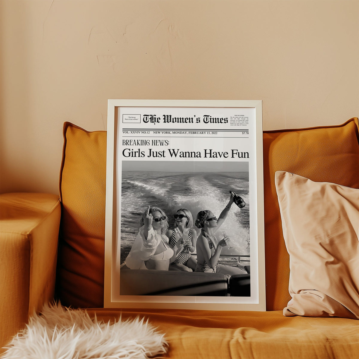Mock front page with three women on a yacht print in a white frame leaning on a mustard velvet sofa
