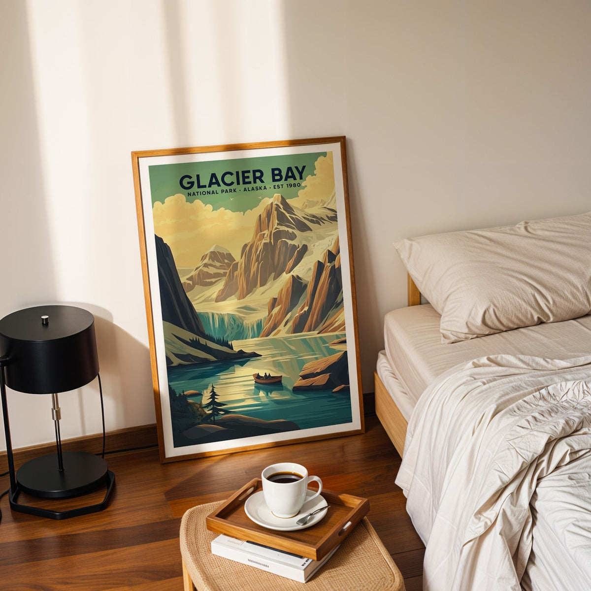 Glacier Bay National Park print in an oak frame leaning on a bedroom floor beside the bed