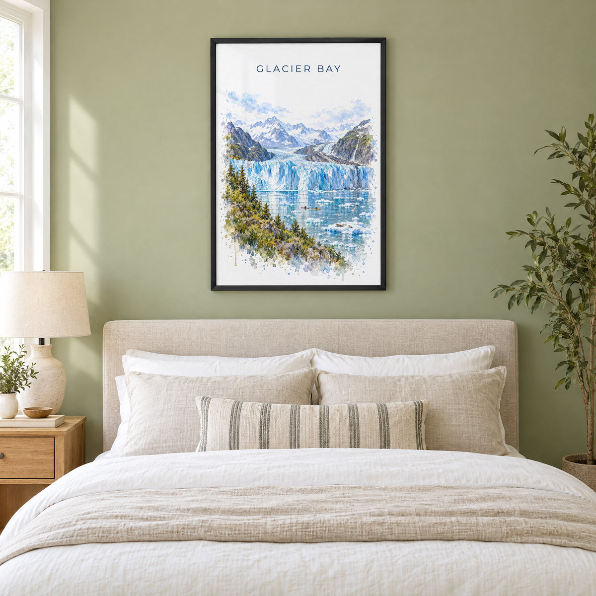 Glacier Bay National Park watercolor print in a black frame above an upholstered headboard in a sage green bedroom